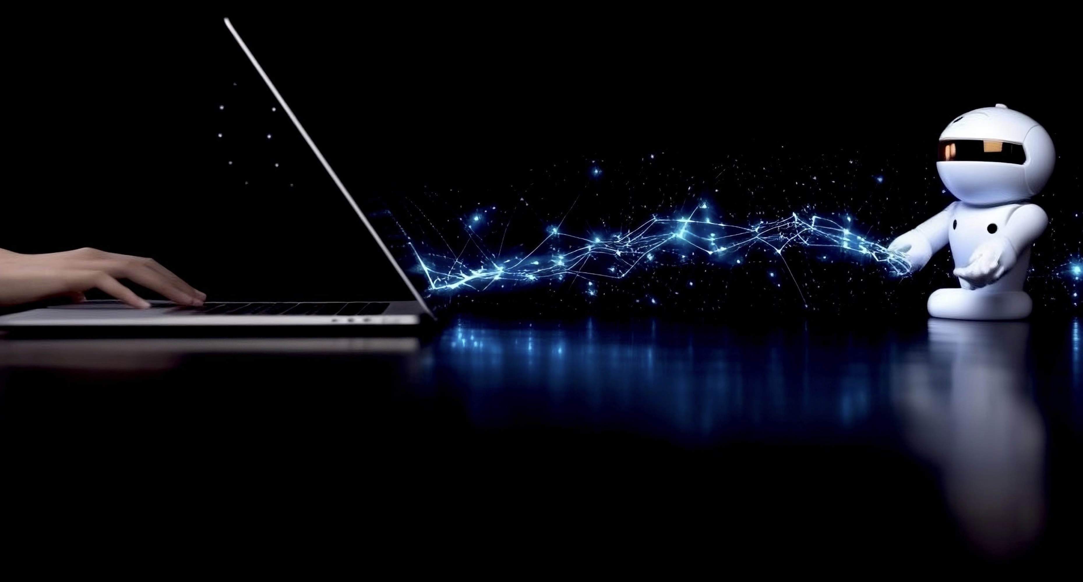 hand on a laptop sending glowing blue sparks to a little humanoid robot